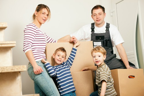 Specialist movers preparing an upright piano for transport