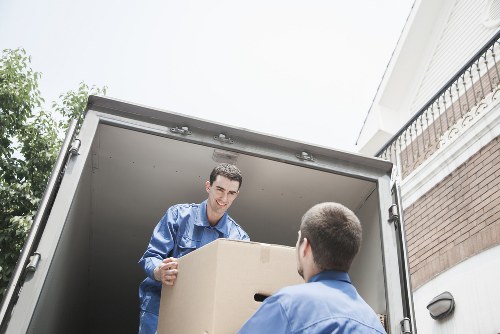 Professional movers coordinating a careful relocation in the middle of the process